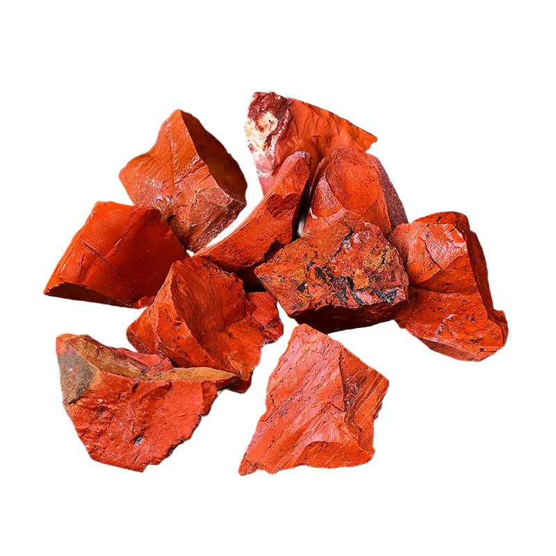 Red stone pieces on a white surface