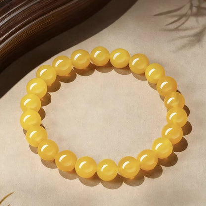 Yellow beaded bracelet on a textured surface