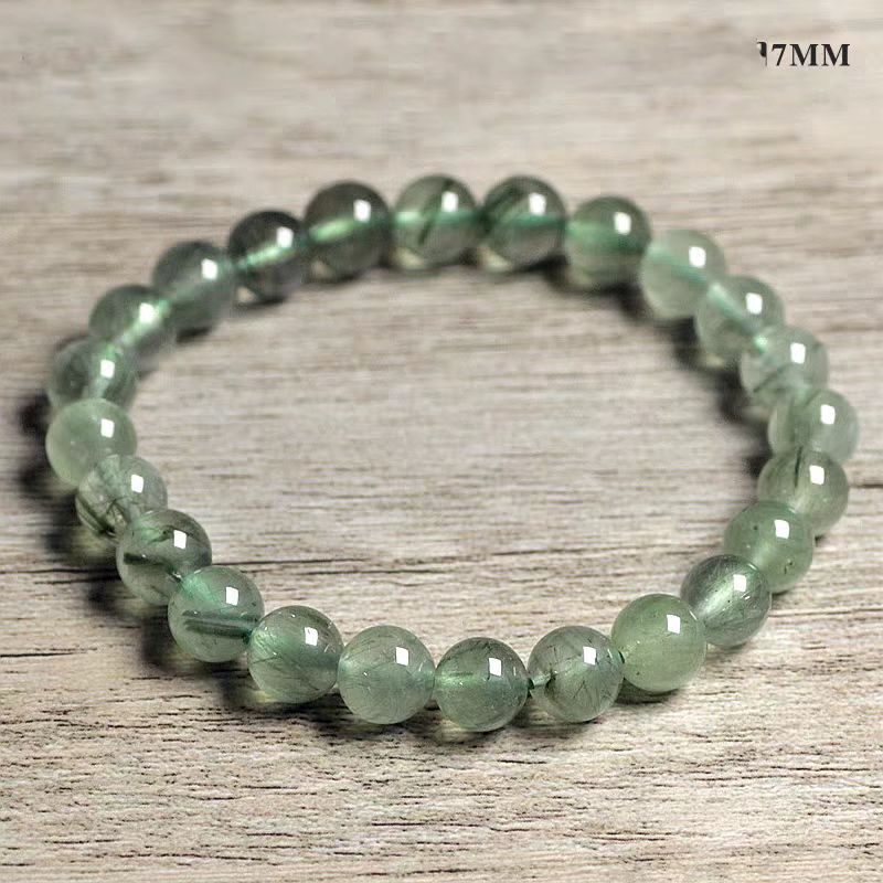 Green beaded bracelet on a wooden surface
