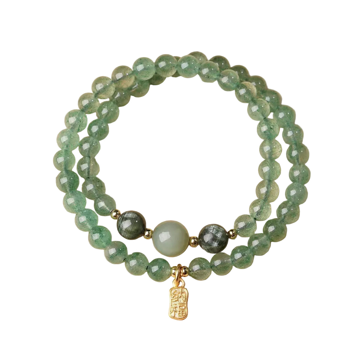 Stack of green beaded bracelets with a gold charm on a beige background