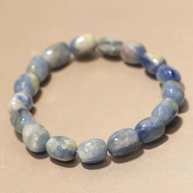 Blue and white beaded bracelet on a beige background
