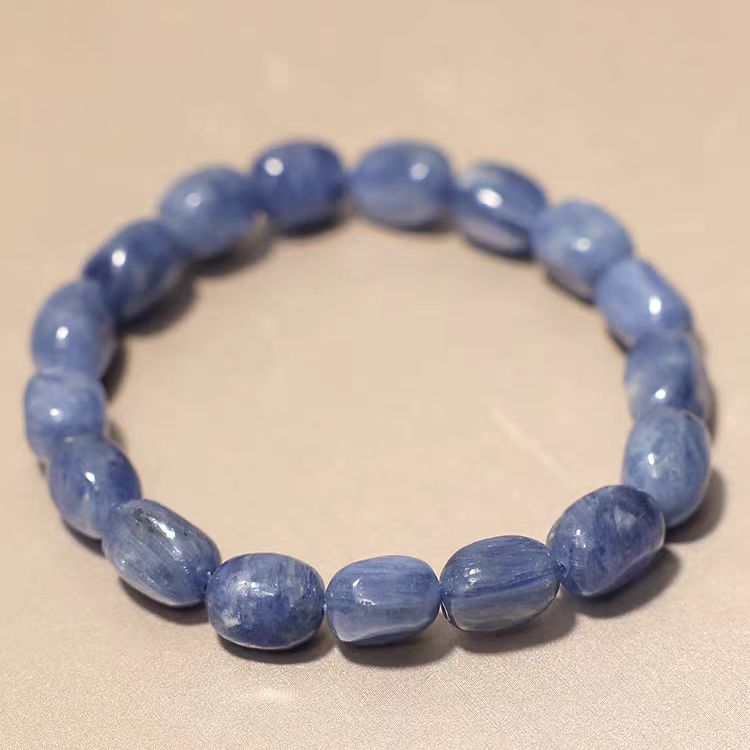 Blue beaded bracelet on a beige background