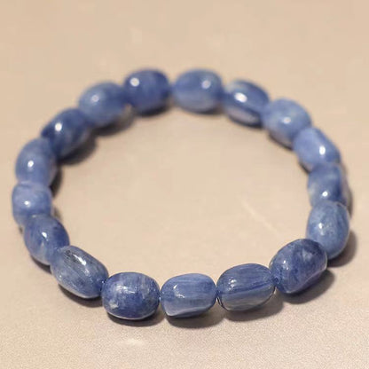 Blue beaded bracelet on a beige background