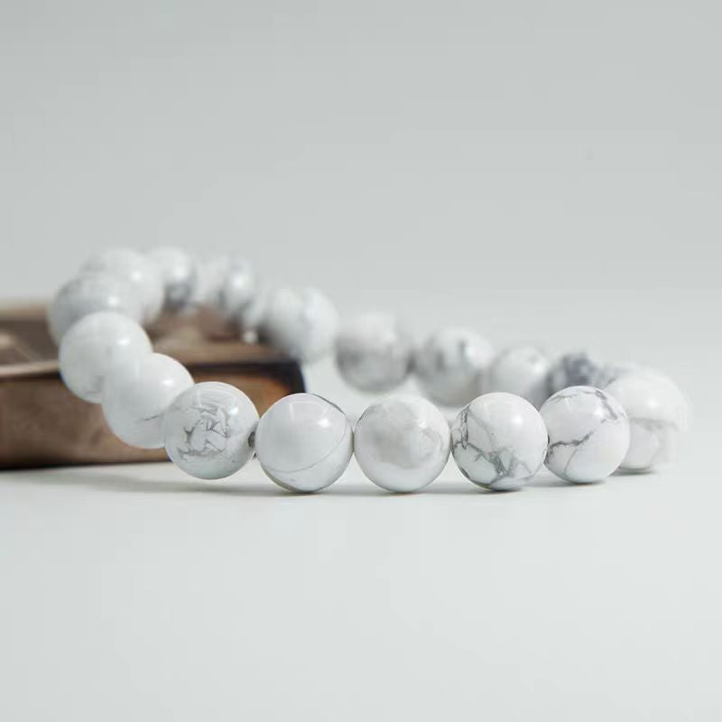 White marble beaded bracelet on a light gray background