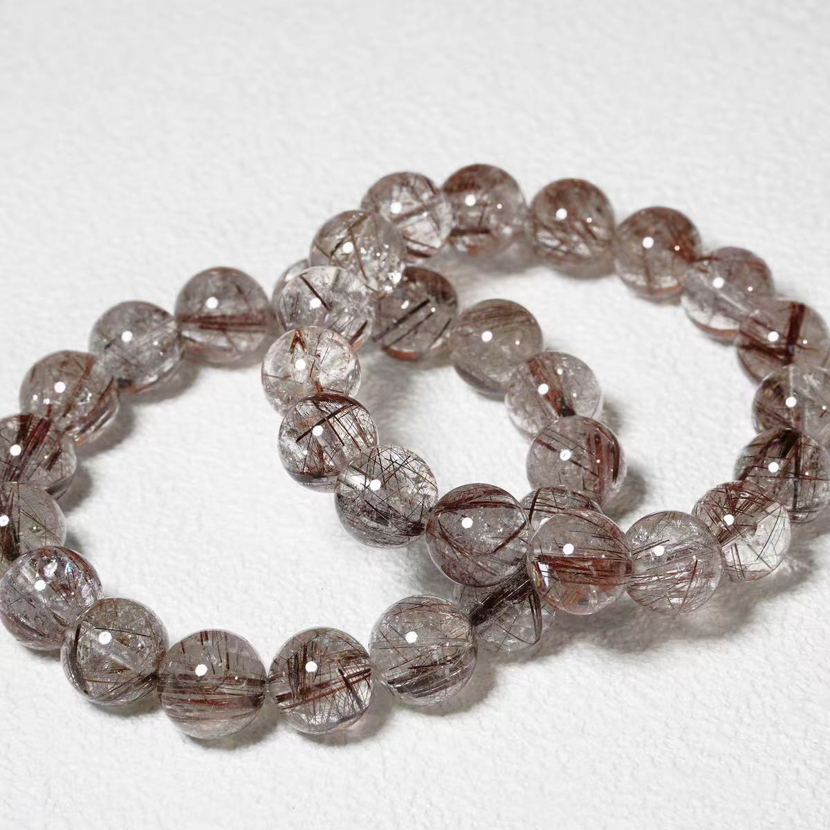Two beaded bracelets on a white background