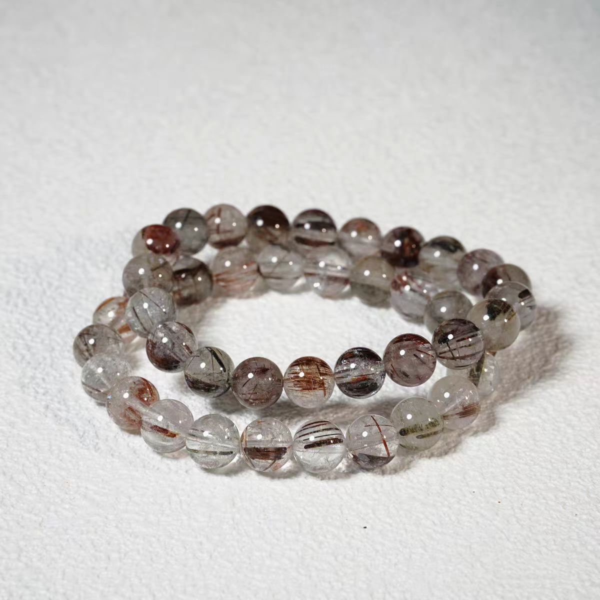 Set of two beaded bracelets on a white background