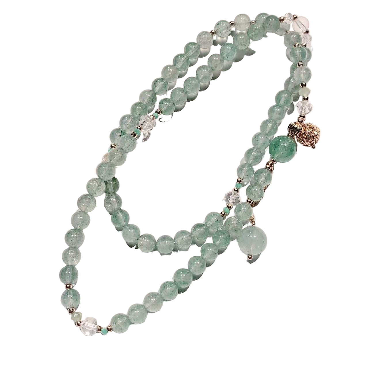 Green beaded bracelet with gold accents on a white background