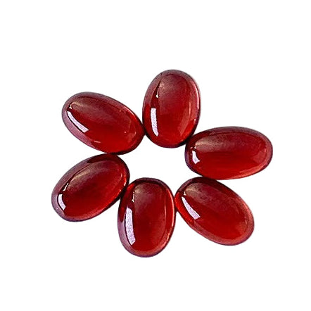 Red gemstones arranged in a circular pattern on a white background