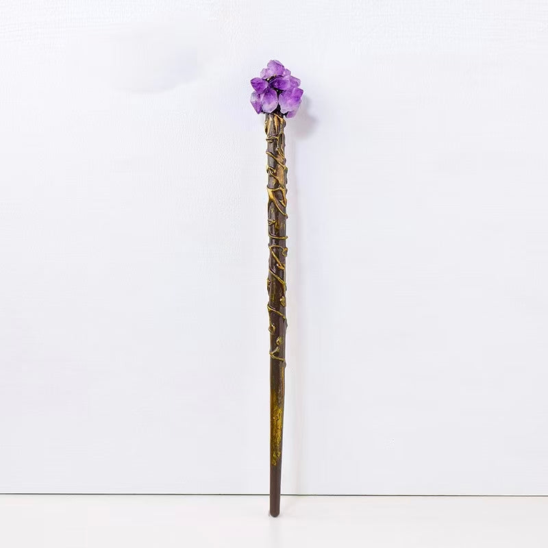 Decorative staff with purple gemstone on a white background
