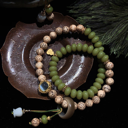 Beaded bracelets on a dark surface with a decorative dish